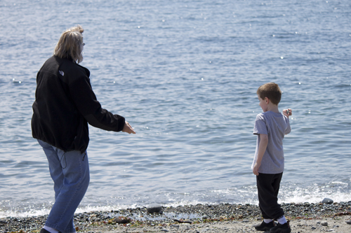 Teaching Grandma how to throw rocks in the water